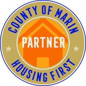 Badge that reads: County of Marin Housing First Partner